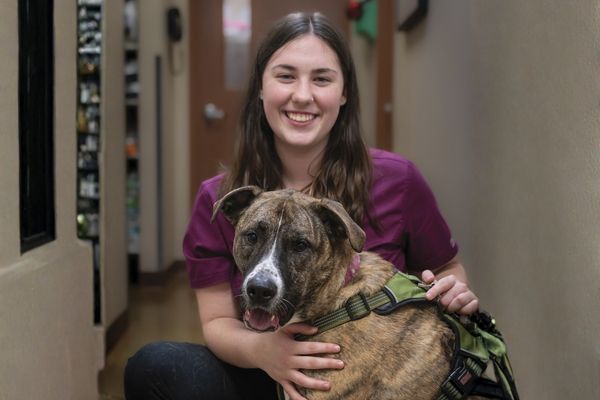 Woman and dog smiling.